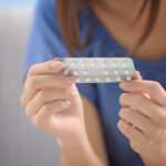 Young slim woman enjoys weight loss result