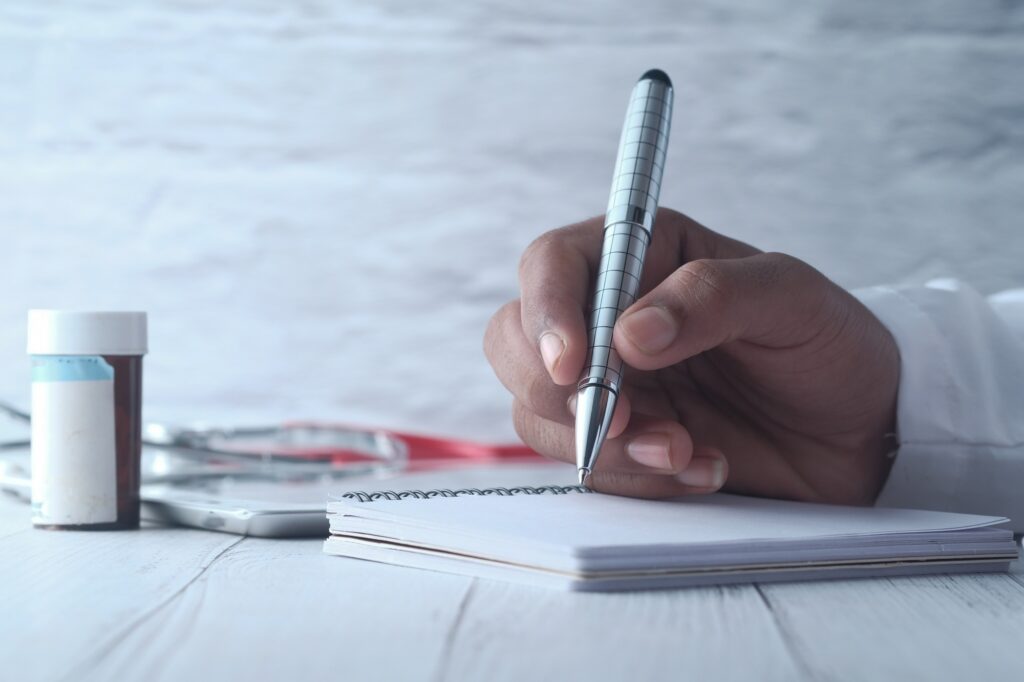 A Doctor is Taking Time to Write a Prescription in a Medical Office Setting Today